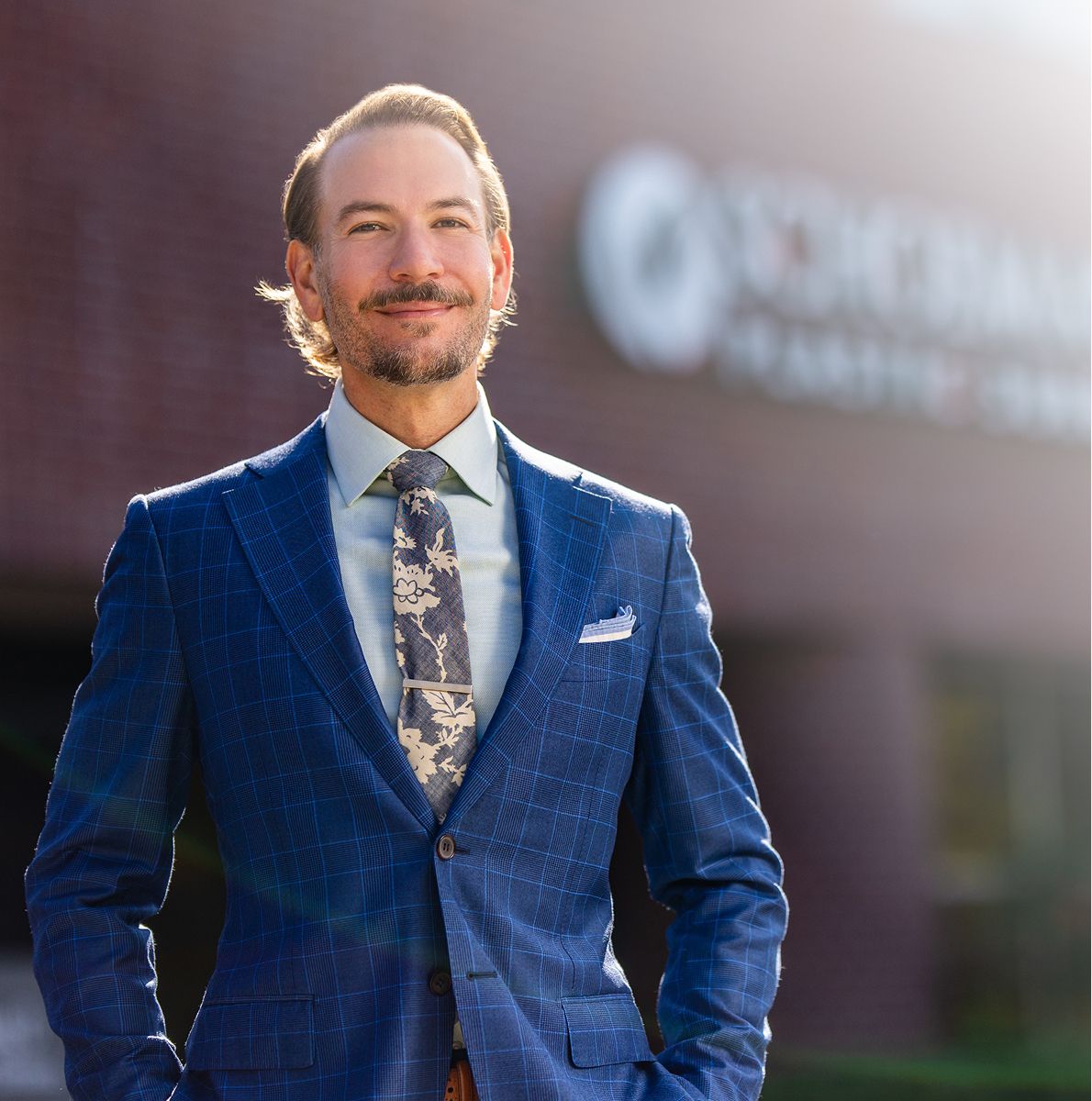 Stylish man in blue suit outdoors.